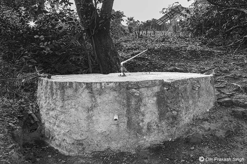 Optimizing traditional drinking water sources for accelerating change - view of the innovative spring-based sanitary well which supplies piped water in Jiyatpani Tola, village Dumarpahar, district Dumka, Jharkhand, also showing the solar panel in the background
